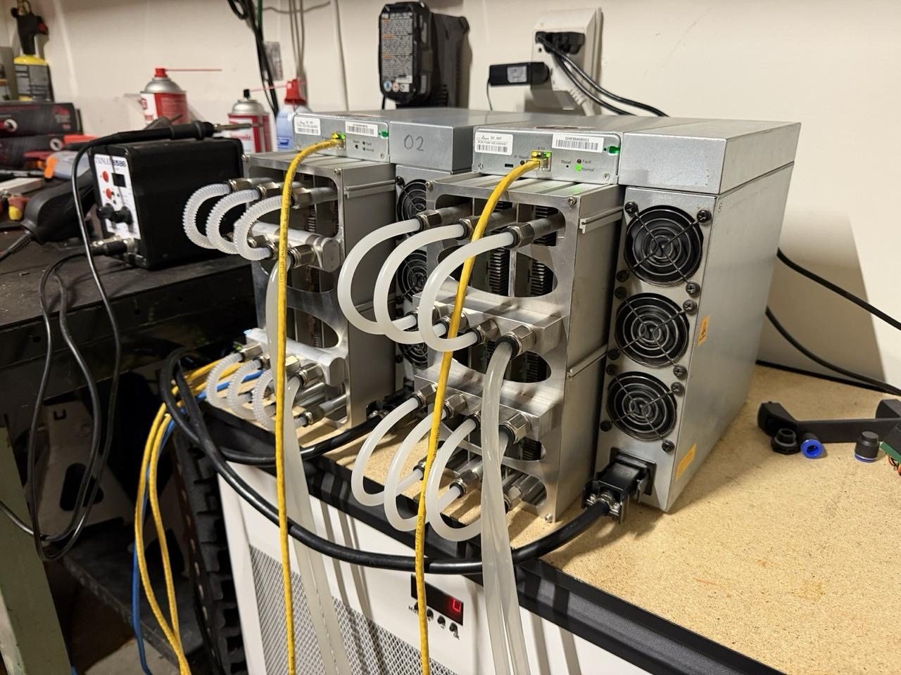 Hydro-converted ASIC miners under test on the BTC Anvil workbench